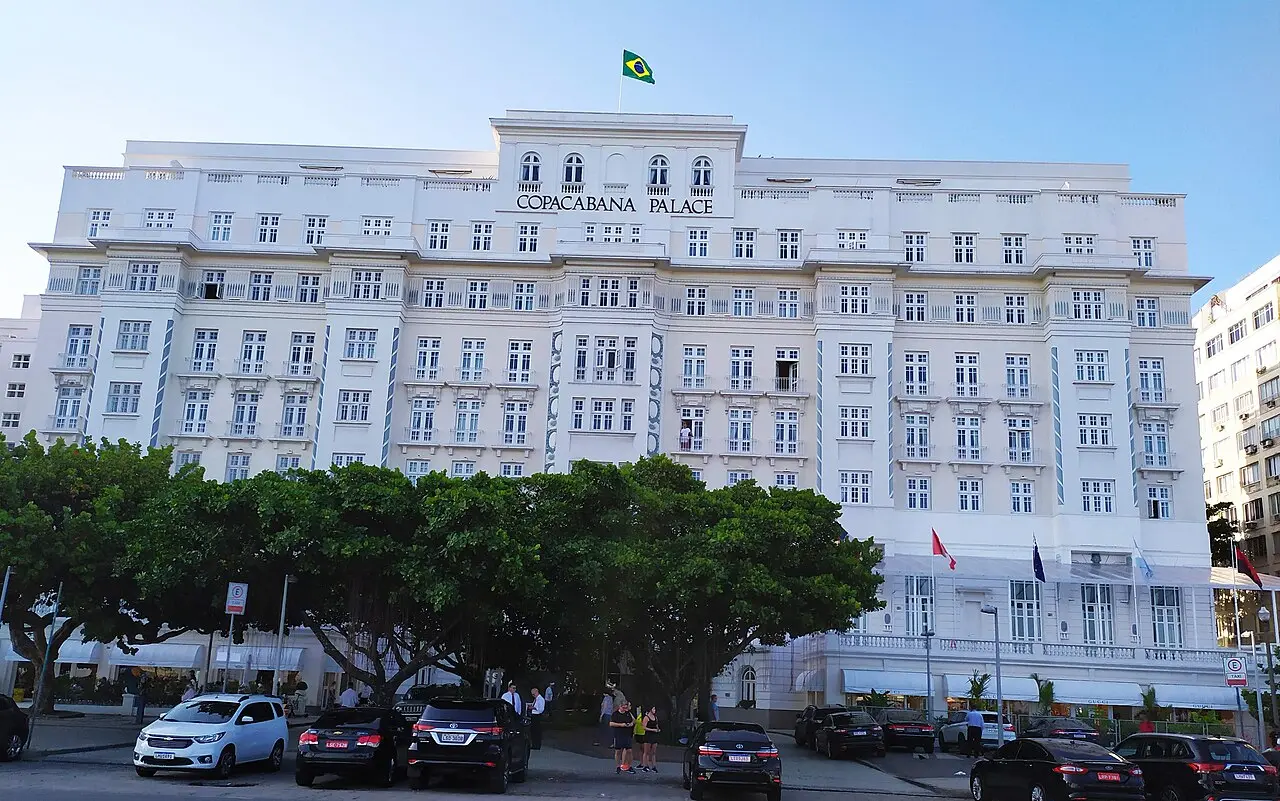 White façade of the Copacabana Palace hotel with the Brazilian flag on top