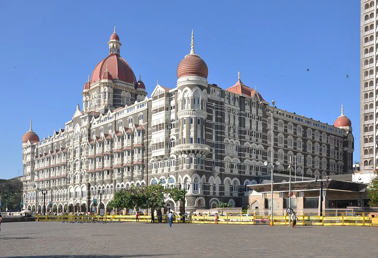 The red-domed Taj Mahal Palace hotel under a clear blue sky in Mumbai